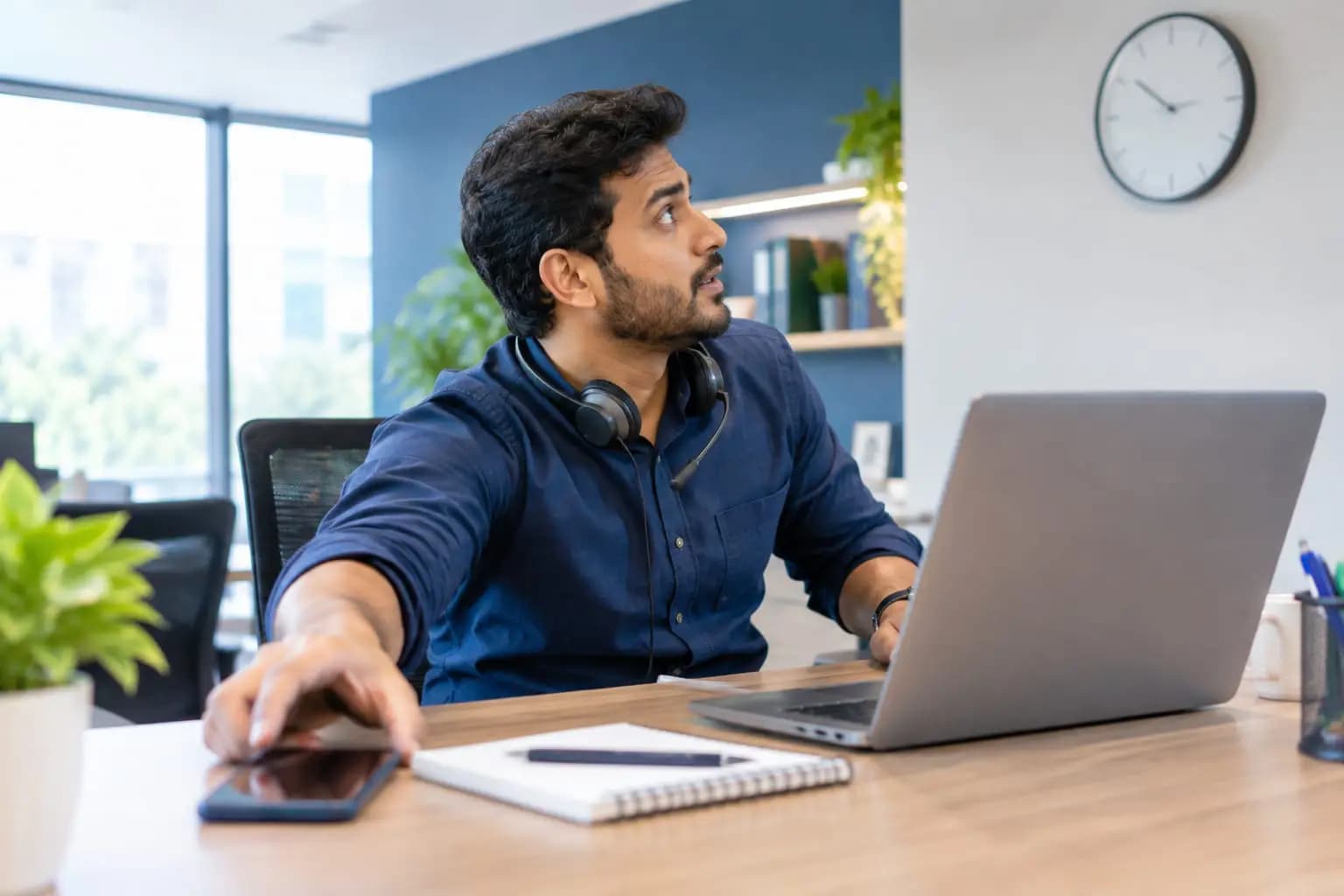 A salesperson answering a phone call quickly at a desk.